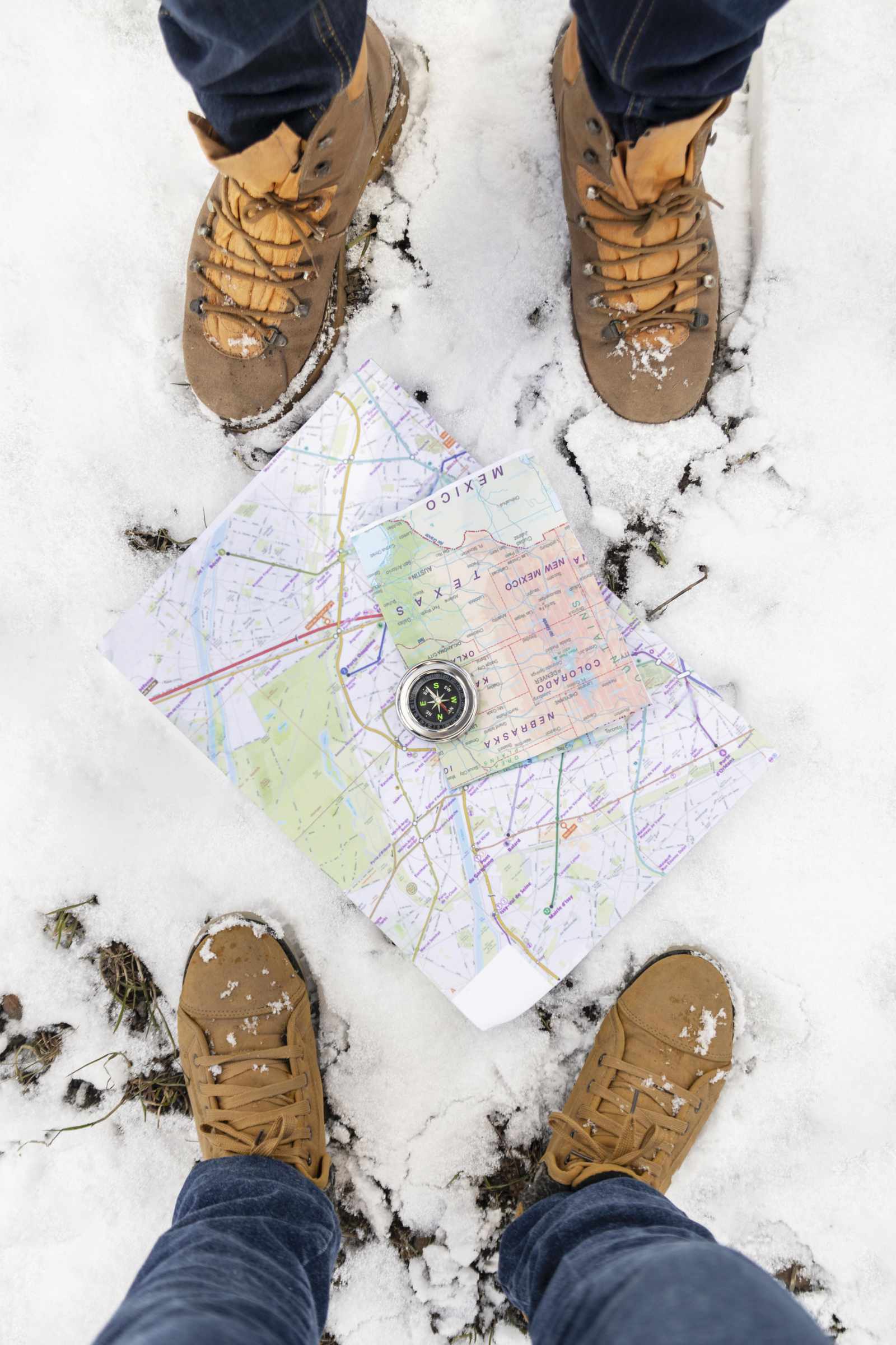 hiking boots view of map laying in snow